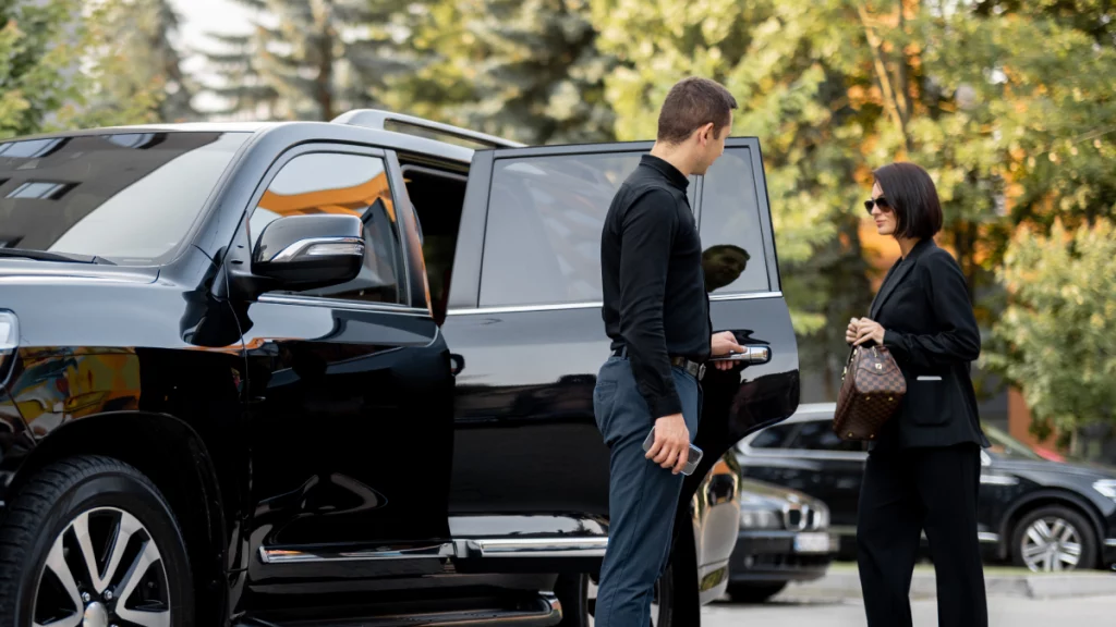 Alt Text: Luxury black car fleet in front of Atlanta Metro Studios Union City GA VIP limousine and chauffeur service
