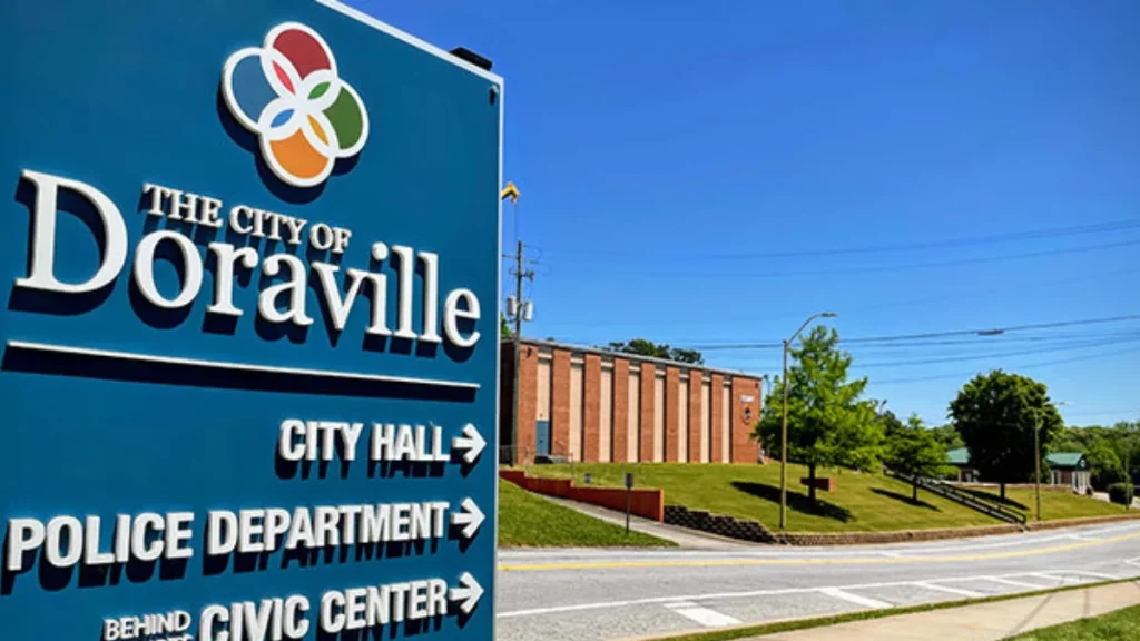 Chauffeur offering executive transportation Doraville with black sedan